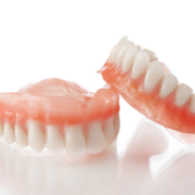 a set of dentures one leaning on the other