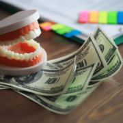 a teeth model with money under the teeth