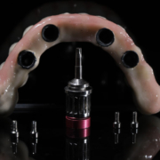 a full mouth dental implants model with tools for placement