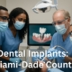 Photo of a diverse group of dental professionals in Miami-Dade County collaborating on a dental implant procedure, showcasing advanced technology. The text on the image reads "Dental Implants: Miami-Dade County".