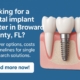 A dental implant graphic showing a gum with teeth and a metal implant, next to text: Looking for a dental implant center in Broward County, FL? Discover options, costs and timelines. Read more now on a blue background.