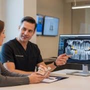 Dentist discussing dental implant options with a patient in a modern setting.